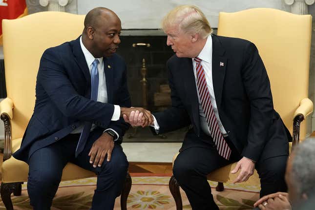WASHINGTON, DC - FEBRUARY 14: U.S. President Donald Trump shakes hands with Sen. Tim Scott (R-SC) during a working session regarding the Opportunity Zones provided by tax reform in the Oval Office of the White House February 14, 2018 in Washington, DC.